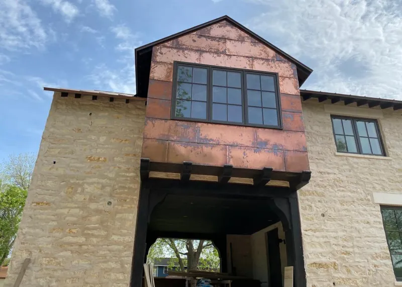 Copper metal panel facade on a stone building for Skylight Installation in Horn Lake